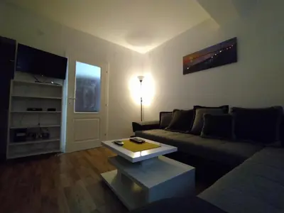 a living room with a couch and a table at Malevilla Apartment in Vrnjačka Banja