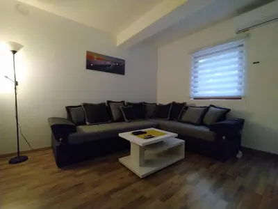 a living room with a couch and a table at Malevilla Apartment in Vrnjačka Banja