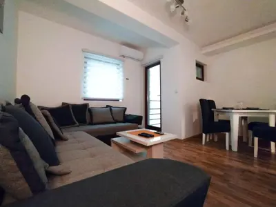 a living room with a couch and a table at Malevilla Apartment in Vrnjačka Banja