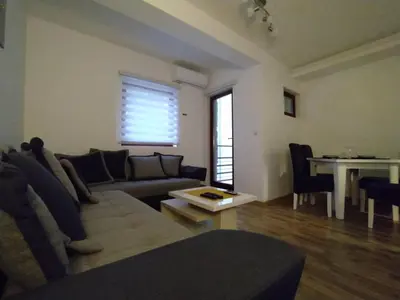 a living room with a couch and a table at Malevilla Apartment in Vrnjačka Banja