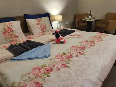 a bed with a stuffed animal sitting on top of it at Guest House Jasmin in Niška Banja