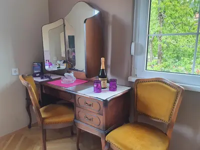 a dressing table with two chairs and a bottle of champagne at Guest House Jasmin in Niška Banja