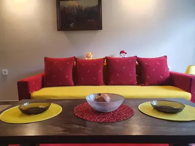 a living room with a couch and a table with two bowls on it at Guest House Jasmin in Niška Banja