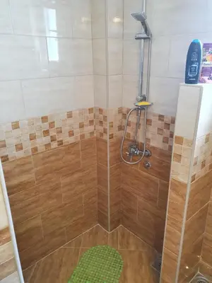 a shower with a glass door in a bathroom at Guest House Jasmin in Niška Banja