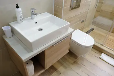 a bathroom with a white sink and a toilet at Zlatna Kruna - Lux Apartments Kopaonik in Kopaonik