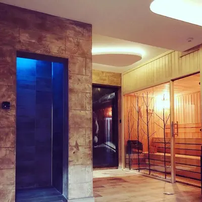 a hallway with a large glass door in a building at Zlatna Kruna - Lux Apartments Kopaonik in Kopaonik
