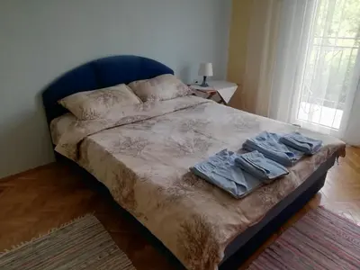 a bedroom with a bed with two towels on it at Sokobanja apartman Aviva in Soko Banja