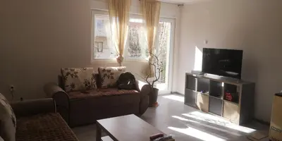 a living room with a couch and a television at Sokobanja apartman Aviva in Soko Banja