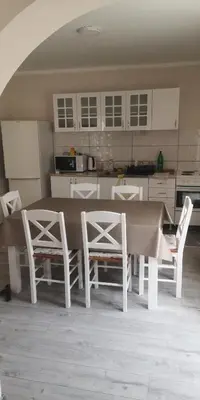 a kitchen with a table and chairs in a room at Sokobanja apartman Aviva in Soko Banja