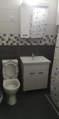 a bathroom with a toilet and a sink and a mirror at Sokobanja apartman Aviva in Soko Banja