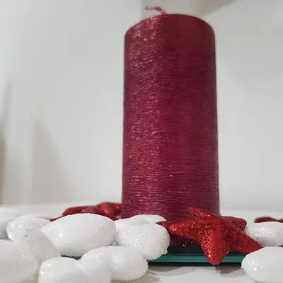 a red candle sitting on top of a pile of rocks at Lena7 in Vrnjačka Banja