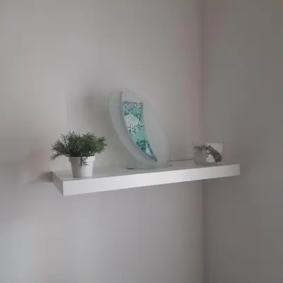 a shelf with a mirror and two plants on it at Lena7 in Vrnjačka Banja