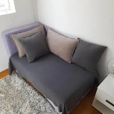 a purple couch with pillows in a room at Lena7 in Vrnjačka Banja