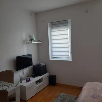 a living room with a television and a window at Lena7 in Vrnjačka Banja