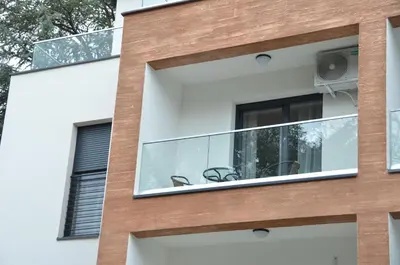 a facade of a house with glass windows at Apartman Rajak in Vrnjačka Banja