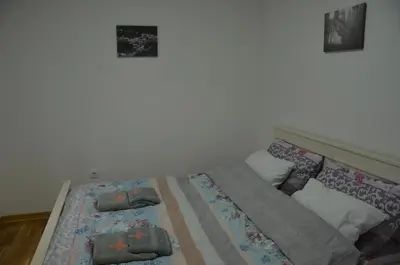 a bed with pillows on it in a bedroom at Apartman Rajak in Vrnjačka Banja