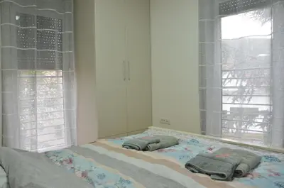 a bed with two pillows on it in a bedroom at Apartman Rajak in Vrnjačka Banja