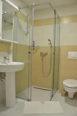 a bathroom with a shower and a sink and a toilet at Apartman Rajak in Vrnjačka Banja