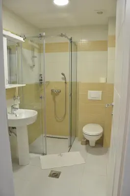 a bathroom with a shower and a toilet and a sink at Apartman Rajak in Vrnjačka Banja