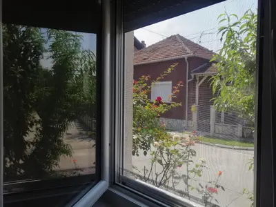 a window with a view of a house at Apartman Nana Jagodina in Jagodina