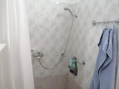 a bathroom with a shower with blue towels at Apartman Nana Jagodina in Jagodina