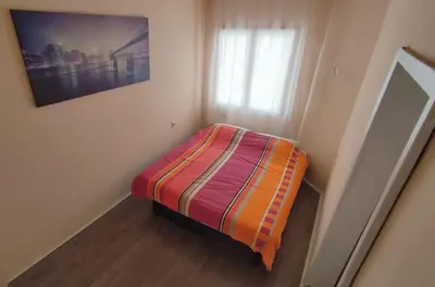 a small bed in a small room with a window at Kuća za odmor Apartman Solo in Soko Banja