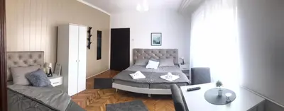 a bedroom with a bed and a desk in it at Smeštaj Filipović in Soko Banja