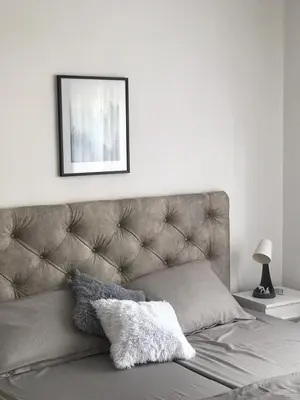 a bed in a bedroom with a picture above it at Smeštaj Filipović in Soko Banja