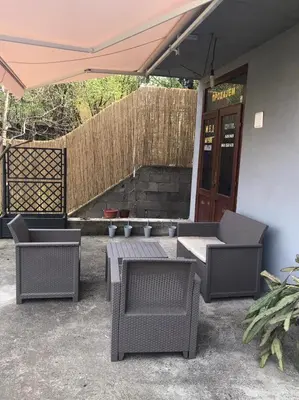 a patio with a table and chairs and an umbrella at Smeštaj Filipović in Soko Banja
