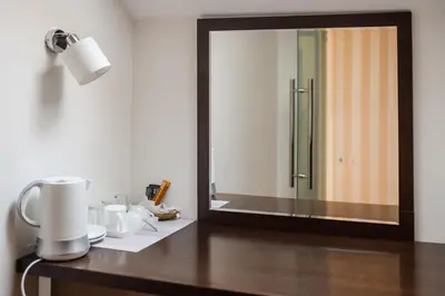 a bathroom vanity with a mirror and a sink at Pleasure Čair apartments in Niš