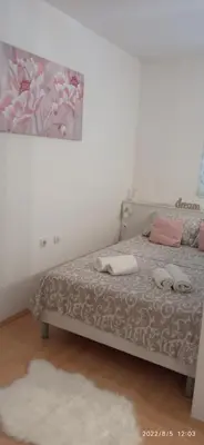 a bedroom with a bed with two towels on it at Emili Apartman in Jagodina