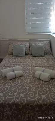 a bed with two pillows on it in a bedroom at Emili Apartman in Jagodina