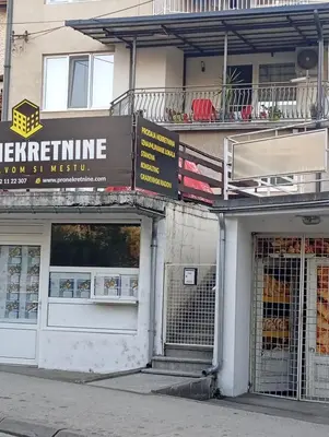 a building with a sign on the side of it at Apartman Bozic in Vrnjačka Banja