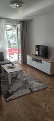 a living room with a tv and a coffee table at Apartman Bozic in Vrnjačka Banja