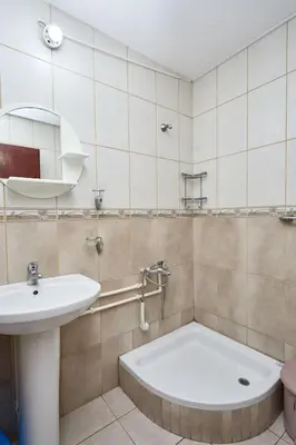 a bathroom with a sink and a bath tub at Apartmani Dr. Gaša in Soko Banja