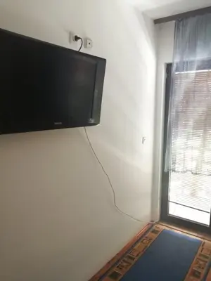 a flat screen tv hanging on a wall next to a window at Apartmani Dr. Gaša in Soko Banja