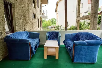 two blue chairs and a table in a room at Apartmani Dr. Gaša in Soko Banja