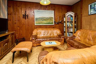 a living room with leather furniture and a tv at Apartmani Dr. Gaša in Soko Banja