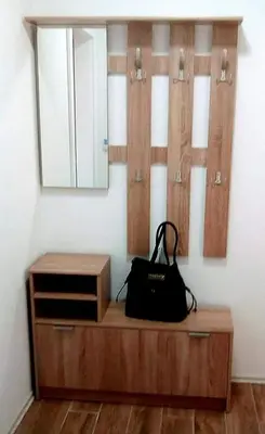 a wooden dresser with a mirror and a purse on it at Apartman RADOVIĆ in Vrnjačka Banja