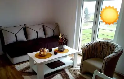 a living room with a couch and a coffee table at Apartman RADOVIĆ in Vrnjačka Banja