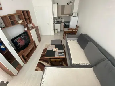a living room with a couch and a table at Apartmani JOVANOVIC Sokobanja in Soko Banja