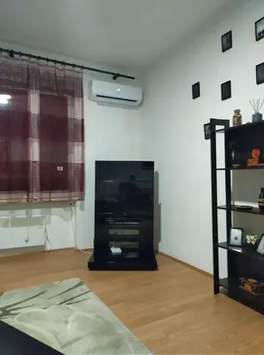 a living room with a flat screen tv in a living room at Viki Apartment CENTAR in Niš