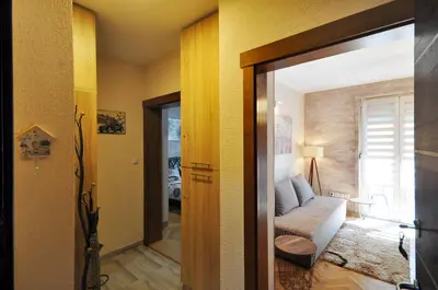 a living room with a couch and a sliding glass door at Apartman Lora in Vrnjci