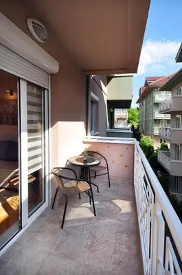a patio with a table and chairs on a balcony at Apartman Lora in Vrnjci