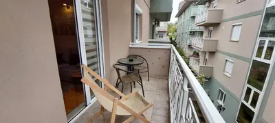a balcony with two chairs and a table on it at Apartman Lora in Vrnjci