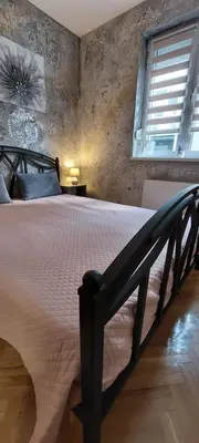 a bedroom with a large bed in a room at Apartman Lora in Vrnjci