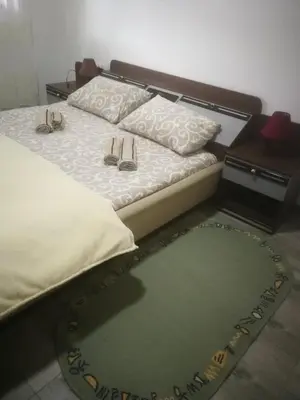 a bed with two pairs of shoes sitting on it at Odmaralište Vlaško ždrelo in Pirot