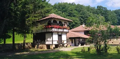 a house with a balcony with flowers on it at Odmaralište Vlaško ždrelo in Pirot