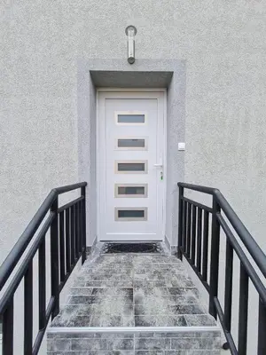 a white door on the side of a building at Apartman Boskovic in Soko Banja