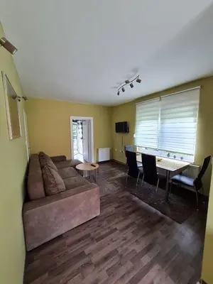 a living room with a couch and a table at Apartman Boskovic in Soko Banja